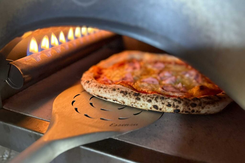 Neapolitanische Pizza wird im Pizzaofen gedreht